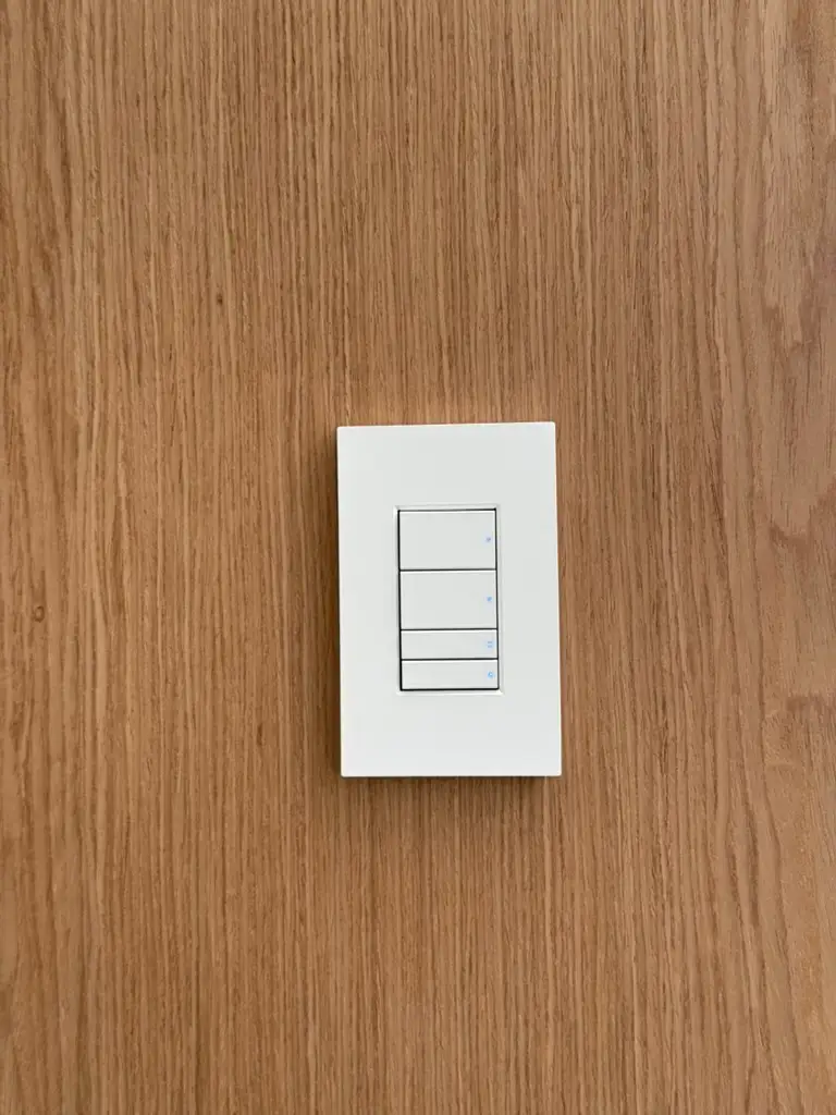 White wall keypad fitted into timber panelling at the Northbridge residence