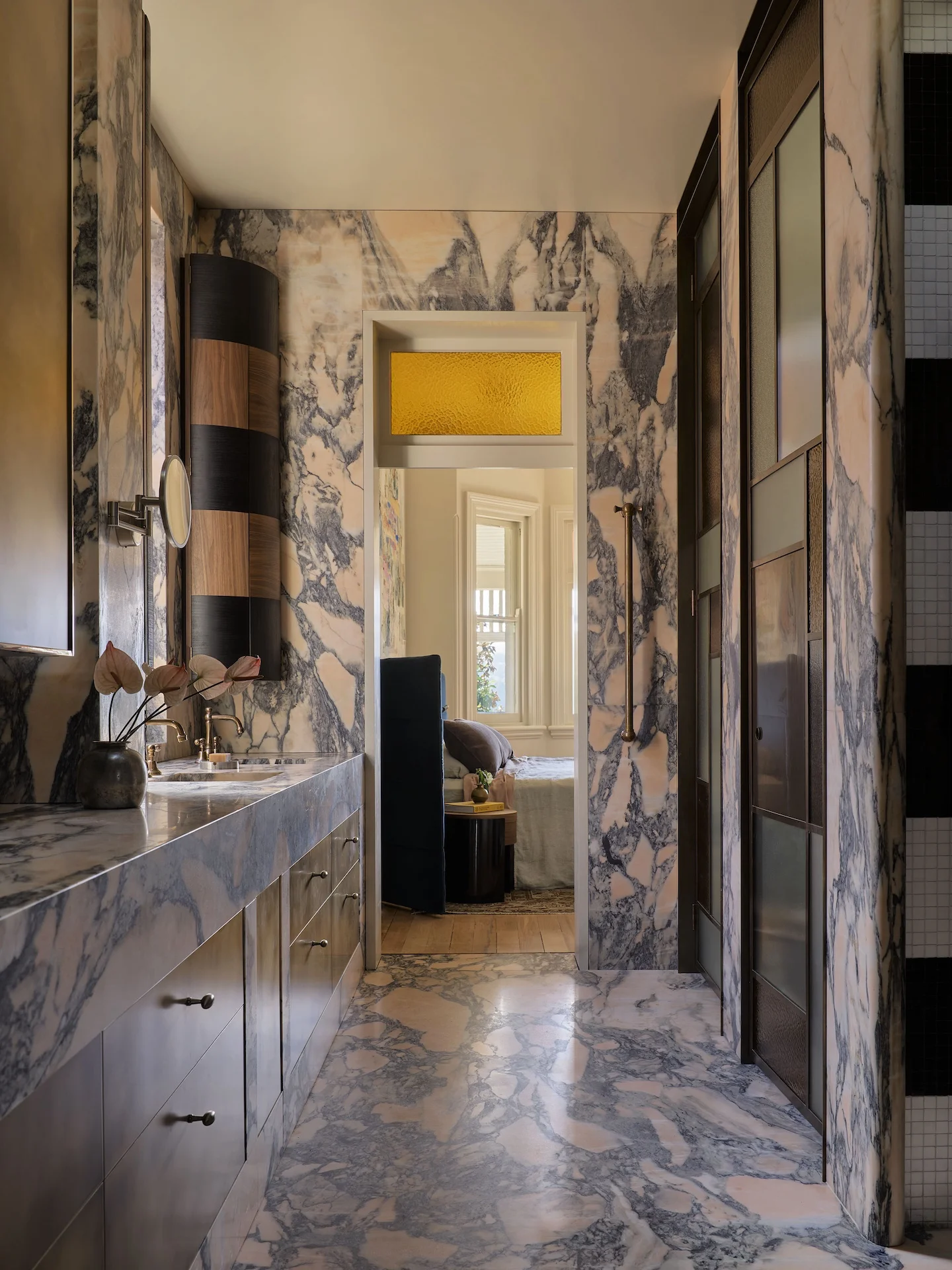 Marble lined ensuite and dressing corridor with concealed lighting and heritage glazing