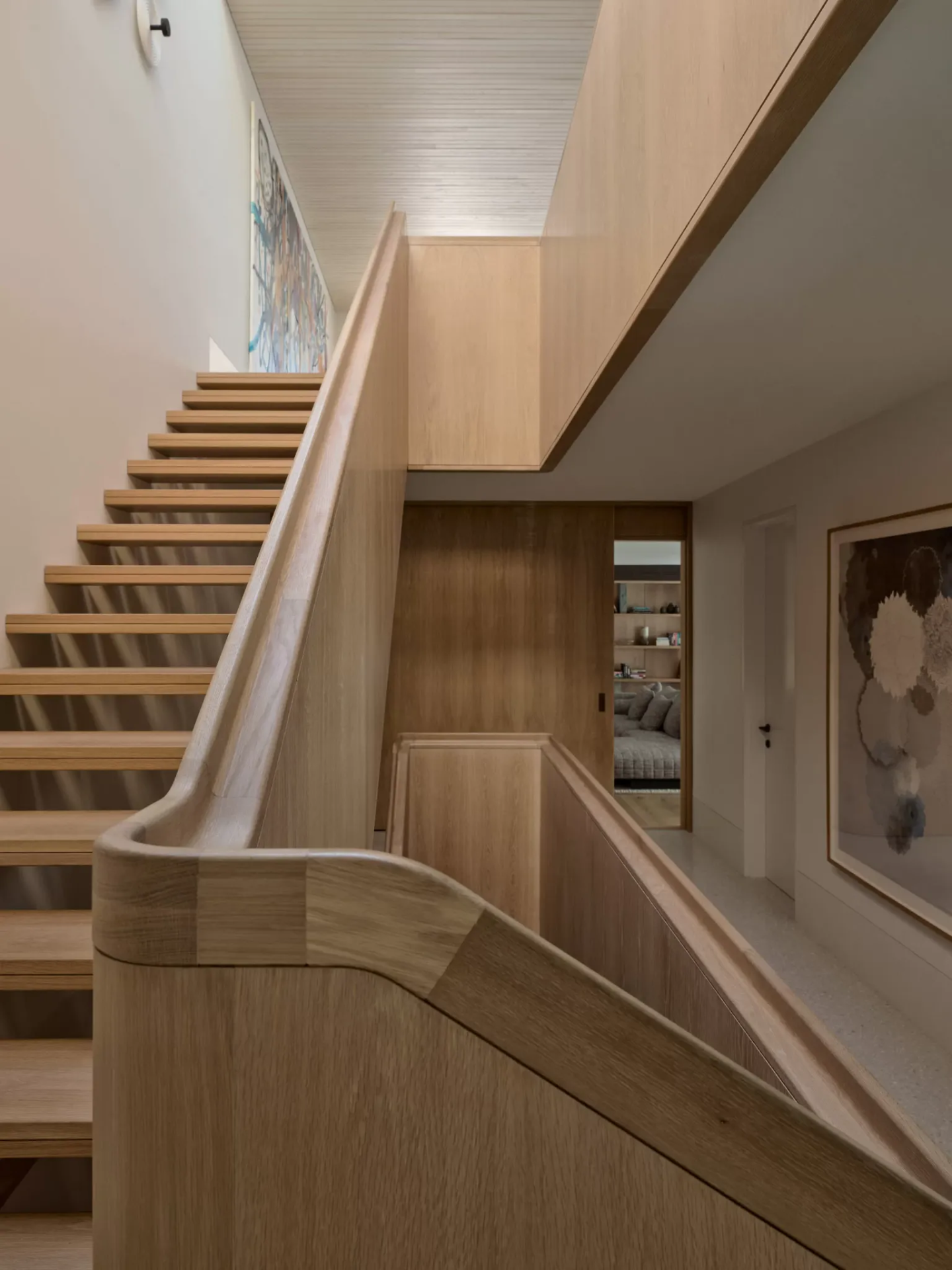 Oak stair and hallway with concealed cove lighting at Bondi residence