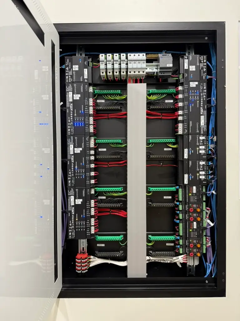 Open residential equipment rack with organised cabling, patch panels and mounted equipment