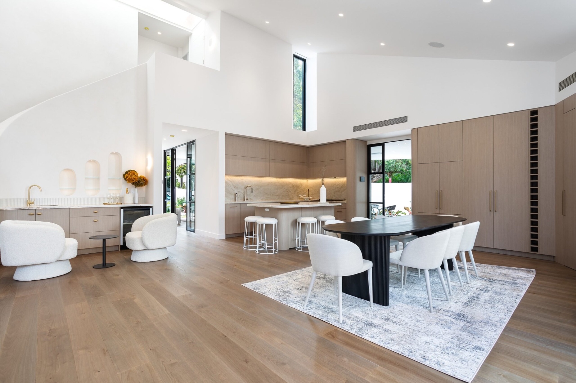 Double height open plan living and dining space with concealed lighting and integrated air conditioning