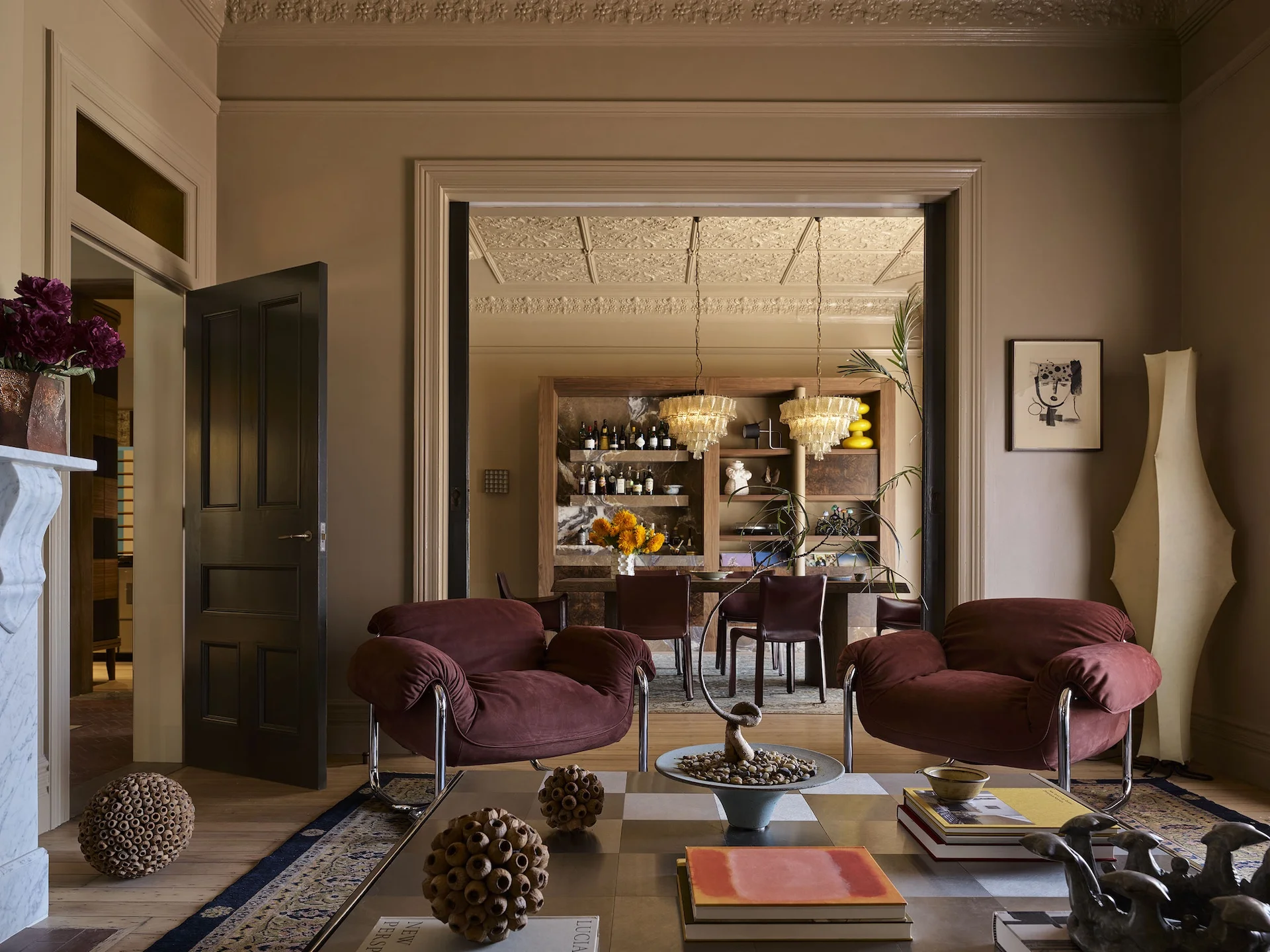 Formal living room opening into a dining room with pressed metal ceilings and integrated audio