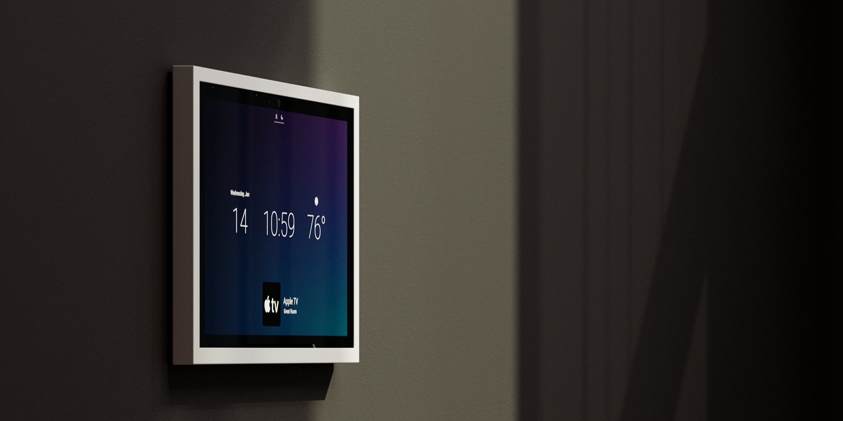 Control4 T5 touchscreen flush-mounted on a dark wall showing time and climate