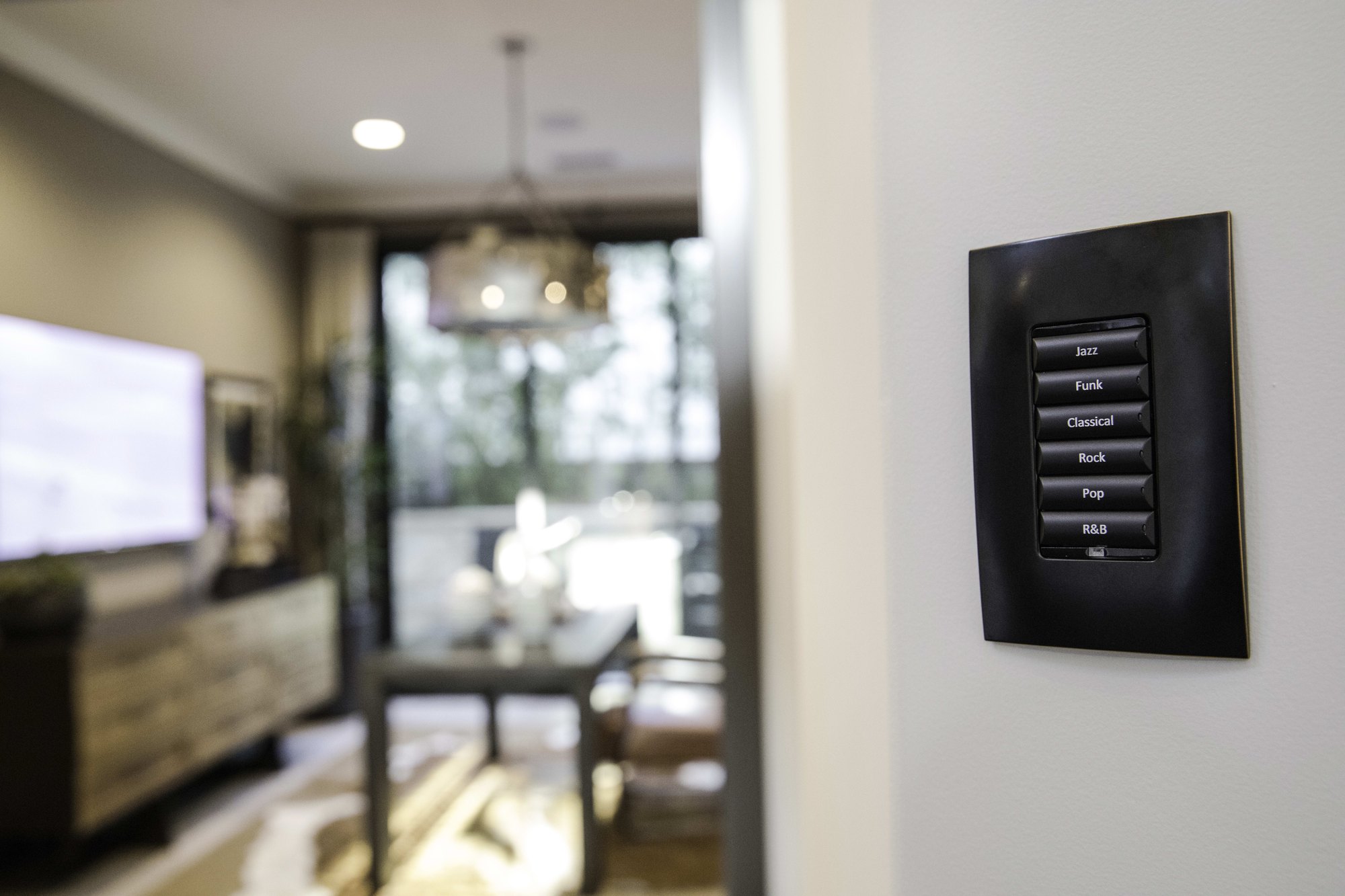 Engraved keypad installed beside a television in a Sydney living room by HTI
