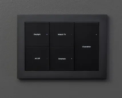 Dark Control4 Lux keypad engraved with room scenes on a dark wall
