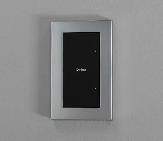 Dark Control4 Lux switch with a metallic faceplate